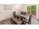Charming dining room with modern table and chairs, wood-look flooring, and access to an outdoor deck at 7308 Rothmore St, Charlotte, NC 28215