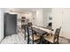 Dining room opens to a modern kitchen, featuring stainless steel appliances and wood-look flooring at 7308 Rothmore St, Charlotte, NC 28215