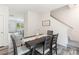 Charming dining room with modern table and chairs, wood-look flooring, and staircase access at 7308 Rothmore St, Charlotte, NC 28215