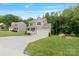 Charming two-story home with a white garage door, a covered porch, and a well-maintained lawn at 7308 Rothmore St, Charlotte, NC 28215