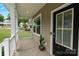 View of the covered front porch with a potted plant, and a view of the neighborhood at 7308 Rothmore St, Charlotte, NC 28215