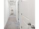 Hallway has neutral carpeting and white doors, leading to bathroom at 7308 Rothmore St, Charlotte, NC 28215