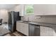 Contemporary kitchen featuring granite countertops, stainless appliances, and tile backsplash at 7308 Rothmore St, Charlotte, NC 28215