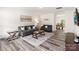 Cozy living room features gray couches, modern decor, and stylish wood-look flooring at 7308 Rothmore St, Charlotte, NC 28215