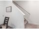 Carpeted staircase with wooden handrail, situated alongside a decorative wall art at 7308 Rothmore St, Charlotte, NC 28215