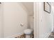 Efficient toilet with storage shelves is nestled within a cozy space at 7308 Rothmore St, Charlotte, NC 28215