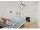 Bright bedroom with light wood floors, ceiling fan and natural light from the windows at 7683 Sarah Dr, Denver, NC 28037