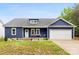 Charming blue home with a covered front porch, white trim, and an attached two car garage at 7683 Sarah Dr, Denver, NC 28037