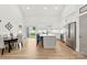 Bright kitchen boasts an island with seating, stainless steel appliances, and an adjacent dining area with sliding glass doors at 7683 Sarah Dr, Denver, NC 28037