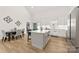 Modern kitchen with a large island, stainless appliances, white cabinets, and an adjacent dining area at 7683 Sarah Dr, Denver, NC 28037
