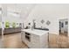 Open-concept kitchen and living area with island, modern appliances, and vaulted ceilings create a spacious and inviting atmosphere at 7683 Sarah Dr, Denver, NC 28037
