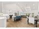A modern kitchen features an island with seating, stainless steel appliances, and an open view into the living room at 7683 Sarah Dr, Denver, NC 28037