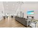 Open-concept living room features a vaulted ceiling, wood floors, and a seamless flow to the modern kitchen at 7683 Sarah Dr, Denver, NC 28037