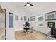 A functional home office features a minimalist desk setup, natural light, and modern decor for a productive workspace at 7683 Sarah Dr, Denver, NC 28037