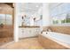 Luxurious bathroom with a soaking tub, glass shower, and vanity with granite countertop at 7738 Burning Ridge Dr, Stanley, NC 28164