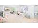 Bright bonus room features a comfortable sofa, large windows, and fun decor at 7738 Burning Ridge Dr, Stanley, NC 28164