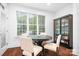 Cozy breakfast nook with round table, chairs, and natural light from large windows at 7738 Burning Ridge Dr, Stanley, NC 28164