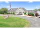 The Cowans Ford Golf Club features a manicured lawn with a clubhouse and an American flag at 7738 Burning Ridge Dr, Stanley, NC 28164