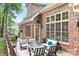 Inviting outdoor deck with a fire pit and comfortable seating with a lush backyard at 7738 Burning Ridge Dr, Stanley, NC 28164