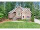 Charming brick home with a well-manicured lawn, mature trees, and inviting front entrance at 7738 Burning Ridge Dr, Stanley, NC 28164