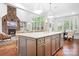 Open-concept kitchen with a large center island, granite countertops, modern appliances, and an eat-in area at 7738 Burning Ridge Dr, Stanley, NC 28164
