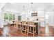 Well-appointed kitchen featuring an island with bar seating, modern appliances, and hardwood floors at 7738 Burning Ridge Dr, Stanley, NC 28164