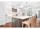 Modern kitchen featuring an island with seating, white cabinets, and stainless steel appliances at 7738 Burning Ridge Dr, Stanley, NC 28164