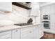 Close-up of a kitchen featuring marble backsplash, stainless steel appliances, and custom cabinetry at 7738 Burning Ridge Dr, Stanley, NC 28164