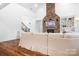 Bright and airy living room with a stone fireplace, built-in shelving, and hardwood flooring at 7738 Burning Ridge Dr, Stanley, NC 28164