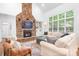 Comfortable living room with stone fireplace, built-in shelves, and ample seating for relaxation and entertainment at 7738 Burning Ridge Dr, Stanley, NC 28164