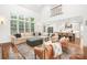 Spacious living room with a soaring ceiling, large windows, hardwood floors, and open to the kitchen at 7738 Burning Ridge Dr, Stanley, NC 28164