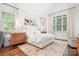 Spacious main bedroom with large windows, hardwood floors, and elegant decor at 7738 Burning Ridge Dr, Stanley, NC 28164