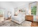 Bright main bedroom with large windows, hardwood floors, and neutral decor at 7738 Burning Ridge Dr, Stanley, NC 28164