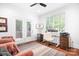 Bright home office with large windows, desk, and view of outdoor space at 7738 Burning Ridge Dr, Stanley, NC 28164