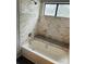Bathroom featuring tiled shower with a tub and marble accents at 8029 Cedar Glen Dr, Charlotte, NC 28212