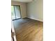 Bright bedroom with wood-look flooring and sliding glass doors leading to outdoor space at 8029 Cedar Glen Dr, Charlotte, NC 28212