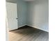 Bright bedroom featuring neutral walls, white trim and wood-look flooring at 8029 Cedar Glen Dr, Charlotte, NC 28212