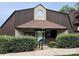 Community clubhouse featuring a brown facade, peaked roof, and lush landscaping for resident's recreational activities at 8029 Cedar Glen Dr, Charlotte, NC 28212