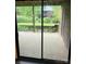 Outdoor patio showcases a tranquil garden and lush landscaping through a sliding glass door at 8029 Cedar Glen Dr, Charlotte, NC 28212