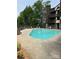 Community pool with clear blue water, surrounded by a concrete deck and mature trees, providing a relaxing outdoor amenity at 8029 Cedar Glen Dr, Charlotte, NC 28212