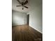 This bedroom boasts a ceiling fan, wood-look flooring, and ample natural light at 843 Spring St, Rock Hill, SC 29730
