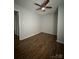 Neutral bedroom featuring wood-look flooring, closet, and doorway to another room at 843 Spring St, Rock Hill, SC 29730