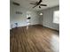 An open-concept living room boasts wood-look floors, a ceiling fan, and ample light at 843 Spring St, Rock Hill, SC 29730