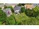 Aerial view of a home featuring a large backyard, a deck with pergola, and mature trees at 8605 Tamarron Dr, Charlotte, NC 28277