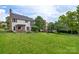Expansive backyard with a well-manicured lawn, deck, and black fence at 8605 Tamarron Dr, Charlotte, NC 28277
