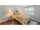 Cozy bedroom with natural light, featuring a floral comforter, bedside tables, and hardwood floors at 8605 Tamarron Dr, Charlotte, NC 28277