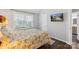 Bedroom with a TV, neutral walls, wood floors, and a window for natural light at 8605 Tamarron Dr, Charlotte, NC 28277