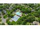 Aerial shot of the community pool, tennis courts, and playground nestled in a lush, green neighborhood at 8605 Tamarron Dr, Charlotte, NC 28277