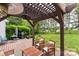 Relaxing outdoor deck with comfortable seating, a grill, and a view of the lush backyard at 8605 Tamarron Dr, Charlotte, NC 28277