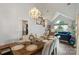 Bright dining room with large table and chairs, chandelier, and flows into the living area at 8605 Tamarron Dr, Charlotte, NC 28277